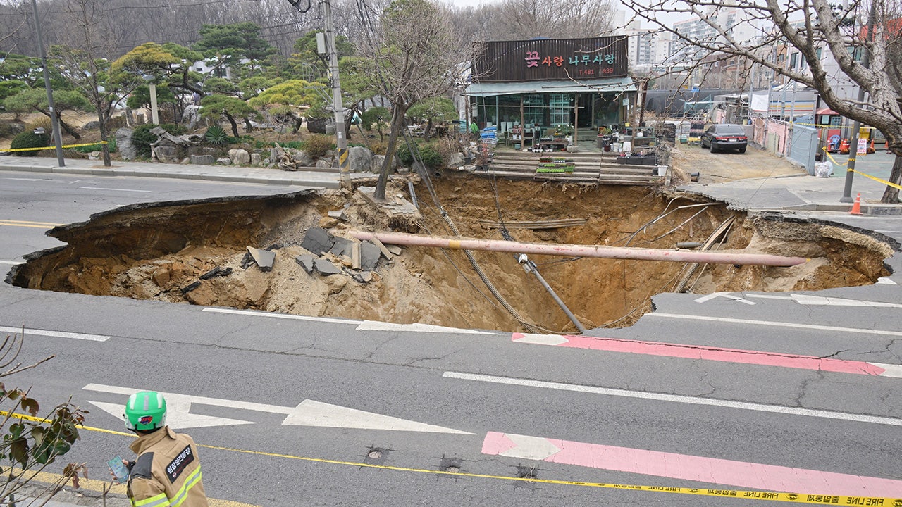 Motorcyclist who disappeared into sinkhole is found dead following search