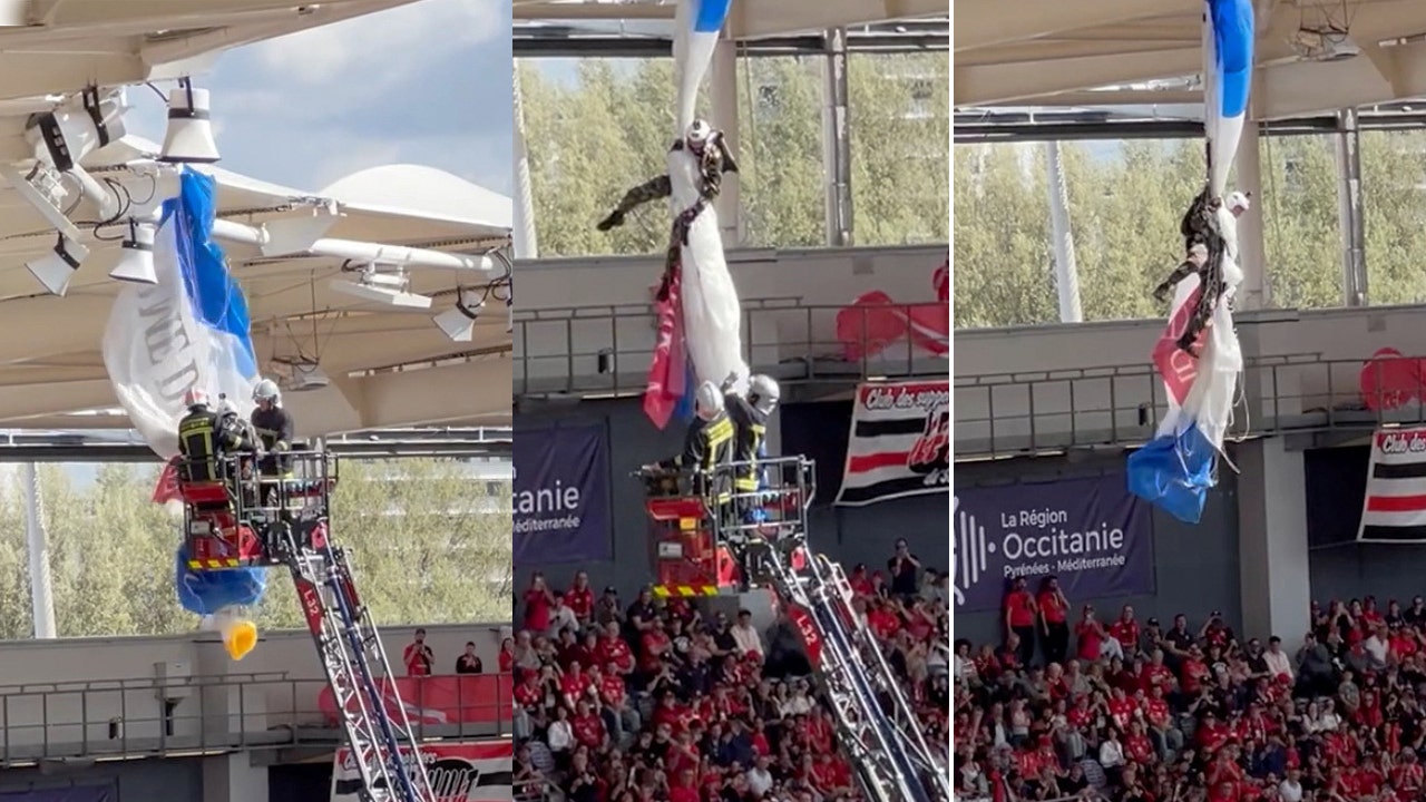 European rugby match gets delayed as parachutist dangles from roof