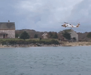 Woman dies after Coast Guard rescues family stranded on island fleeing boat fire
