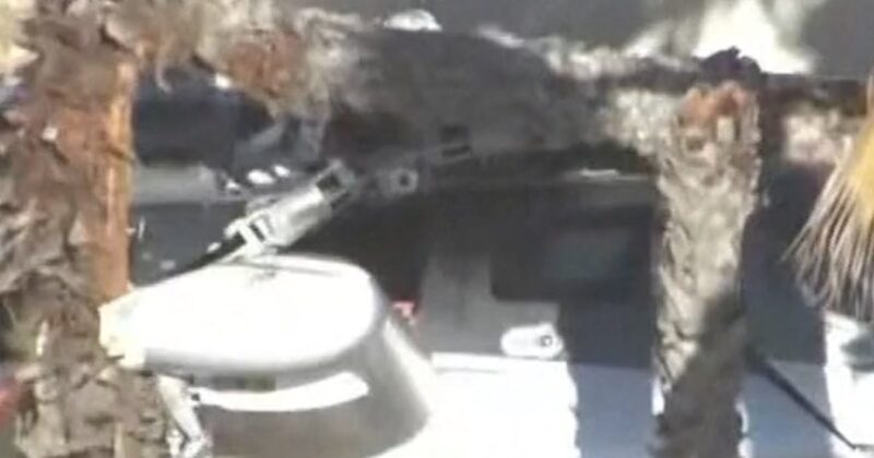 Helicopter crashes into California building