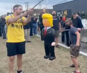 Child at ‘No Kings’ protest stabs at Trump piñata
